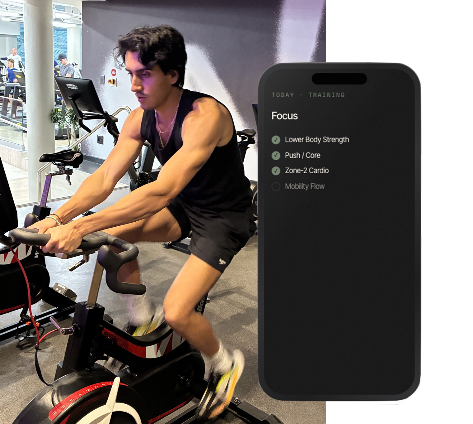 An ORDO member training on a spin bike, with the ORDO Card showing their training focus for the day